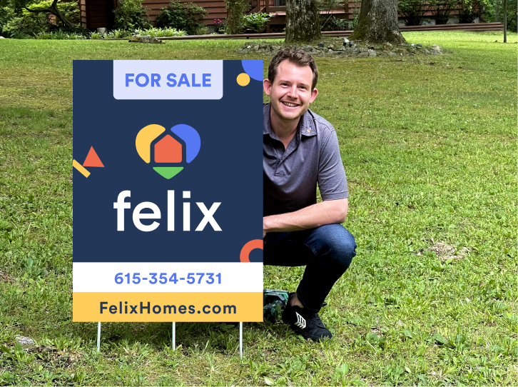 Tyler holding a for sale sign